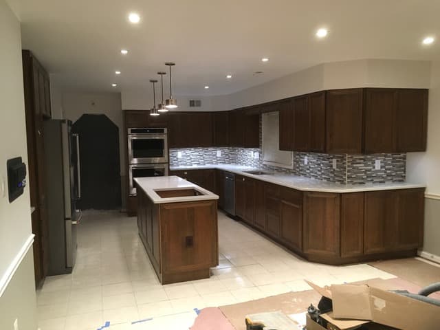 Dark wood shaker kitchen with stone countertops
