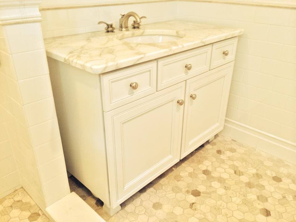 White shaker bathroom vanity with stone top